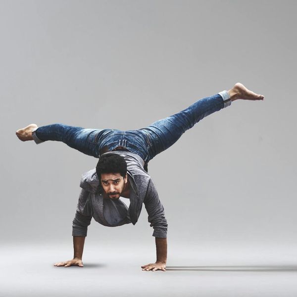 Person performing an advanced yoga balance pose with strength.